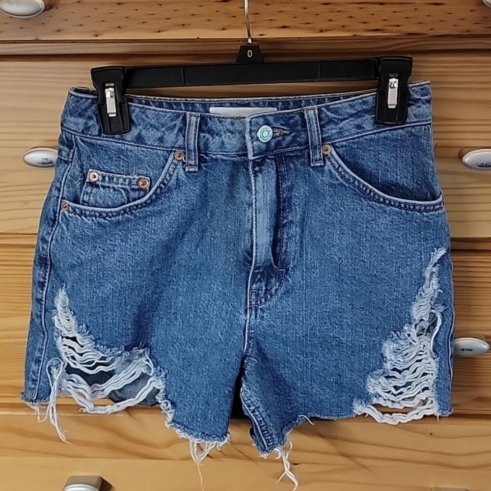 Topshop high-rise distressed denim shorts.